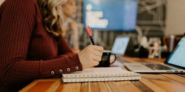 Kate working at a desk measuring churn for syrup