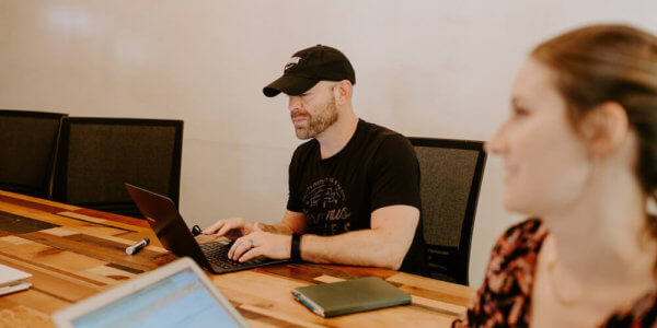 Jason working on his computer writing his blog post on focus and why less is more