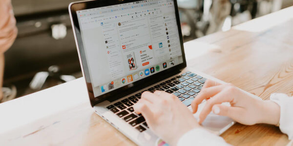 Two hands typing on a laptop on LinkedIn