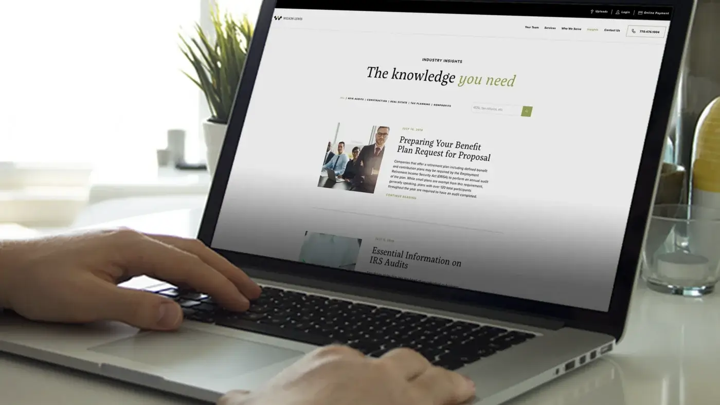 Wilson Lewis Insights webpage shown on laptop computer