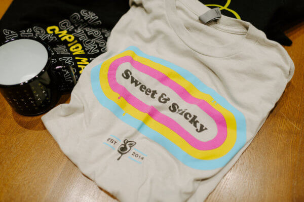 Syrup branded shirts and coffee mug on a table