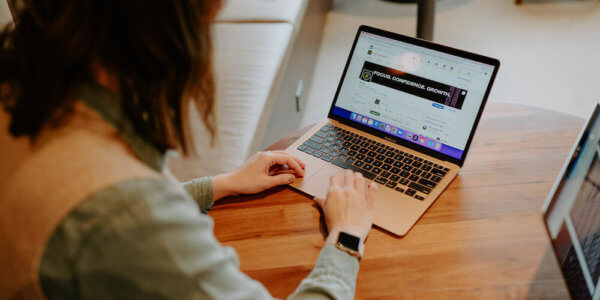 girl looking at her laptop with a brand's core purpose displayed on the screen