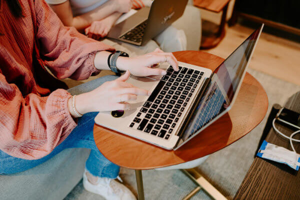 Madison, Syrup team member, typing a clear message on a laptop computer