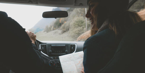 Two people in a car on a road trip