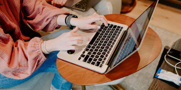 Girl typing on laptop computer about buying email marketing list