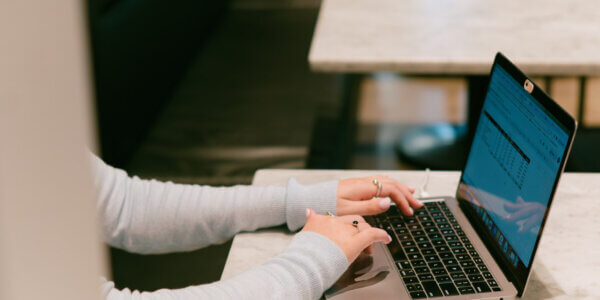 Girl typing on laptop computer working on improving SEO for a website
