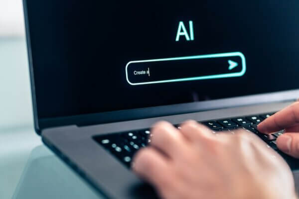Trained AI prompt on computer laptop with hands typing