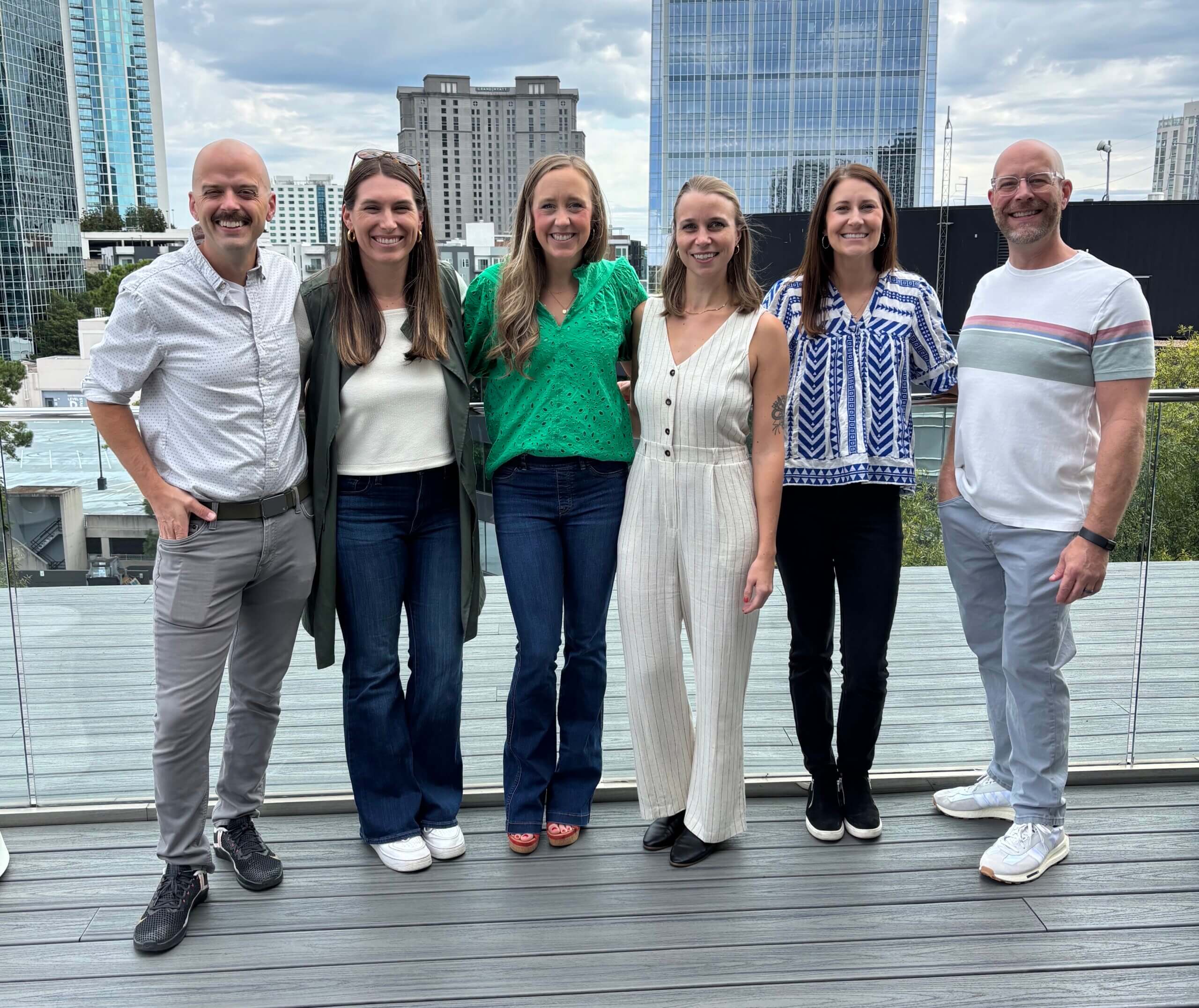 Group of Syrup team at event with Atlanta in the background