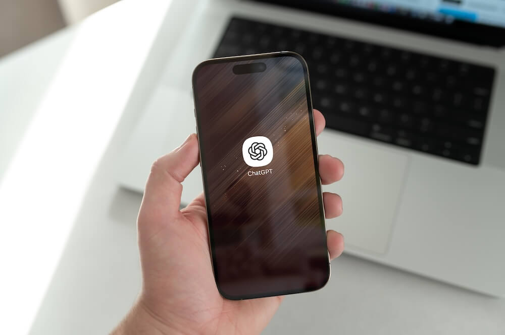 Hands holding phone with ChatGPT app pulled up - showing up in AI answers