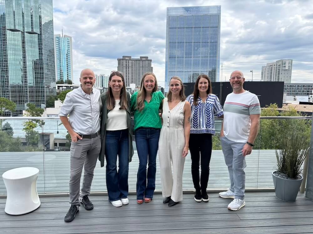 Group of Syrup team at event with Atlanta in the background