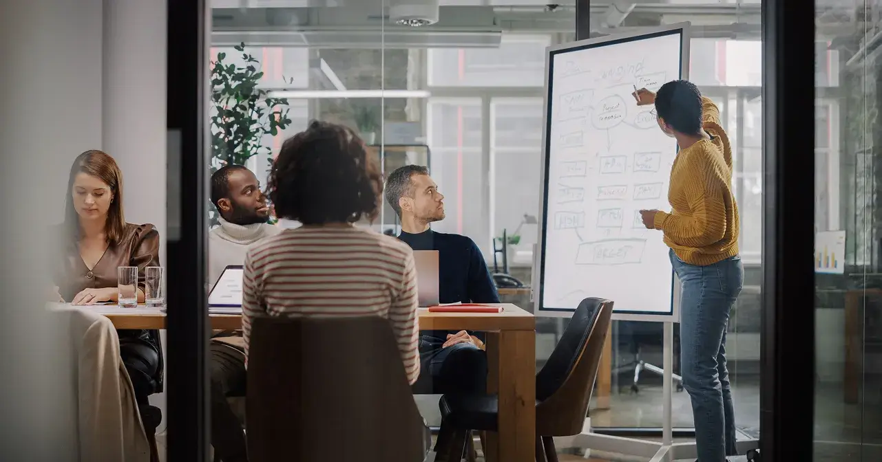 People working in meeting room talking about strategy