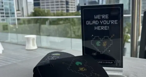 Sign and koozies from Syrup and Consume Media client event