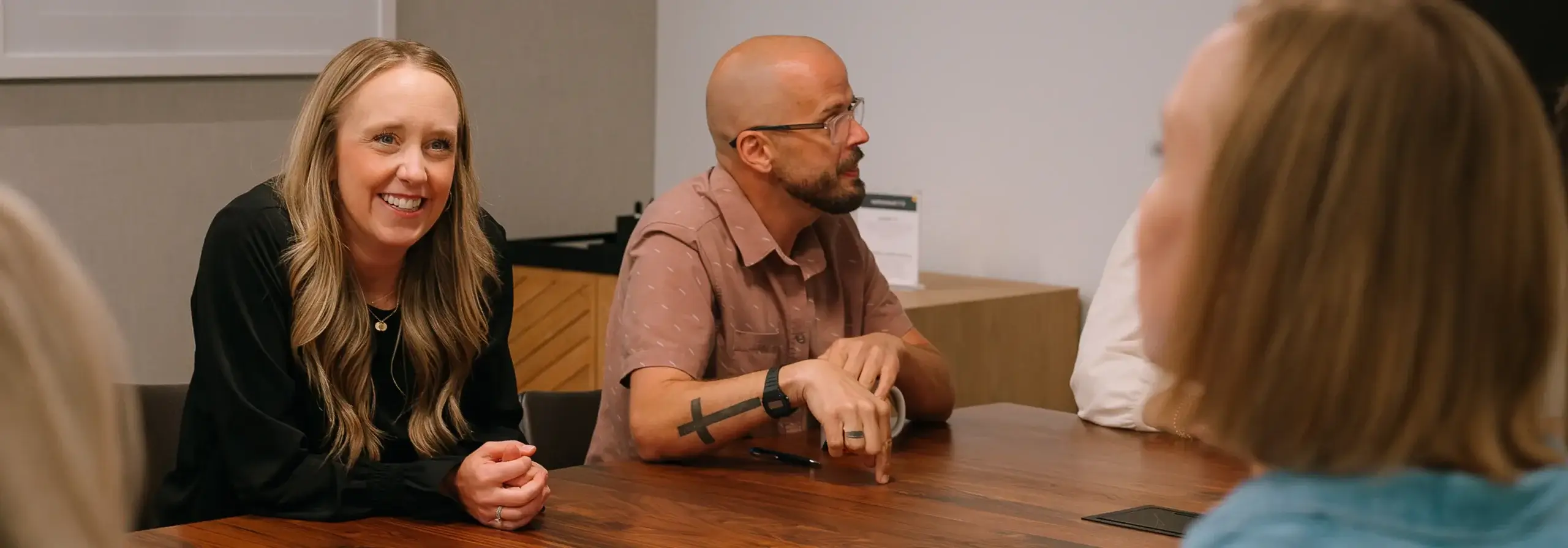 AEO SEO Agency team members sitting around a table discussing aeo