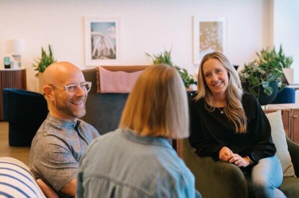 Kate, Jason and Jordan-Ann sitting on a couch discussing 2025