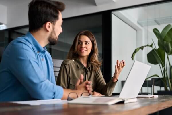 Man and woman meeting in office to discuss building buyer personas