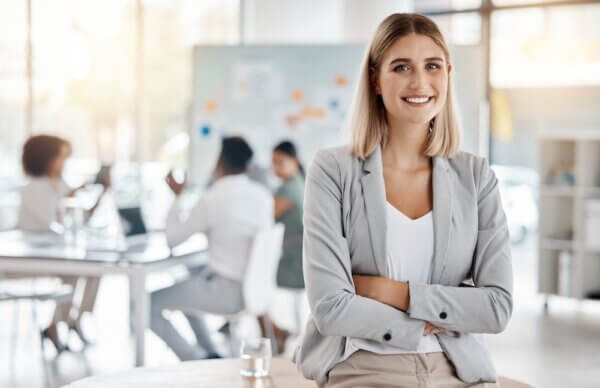 Woman in business suit sits in front of her team discussing proving marketing ROI