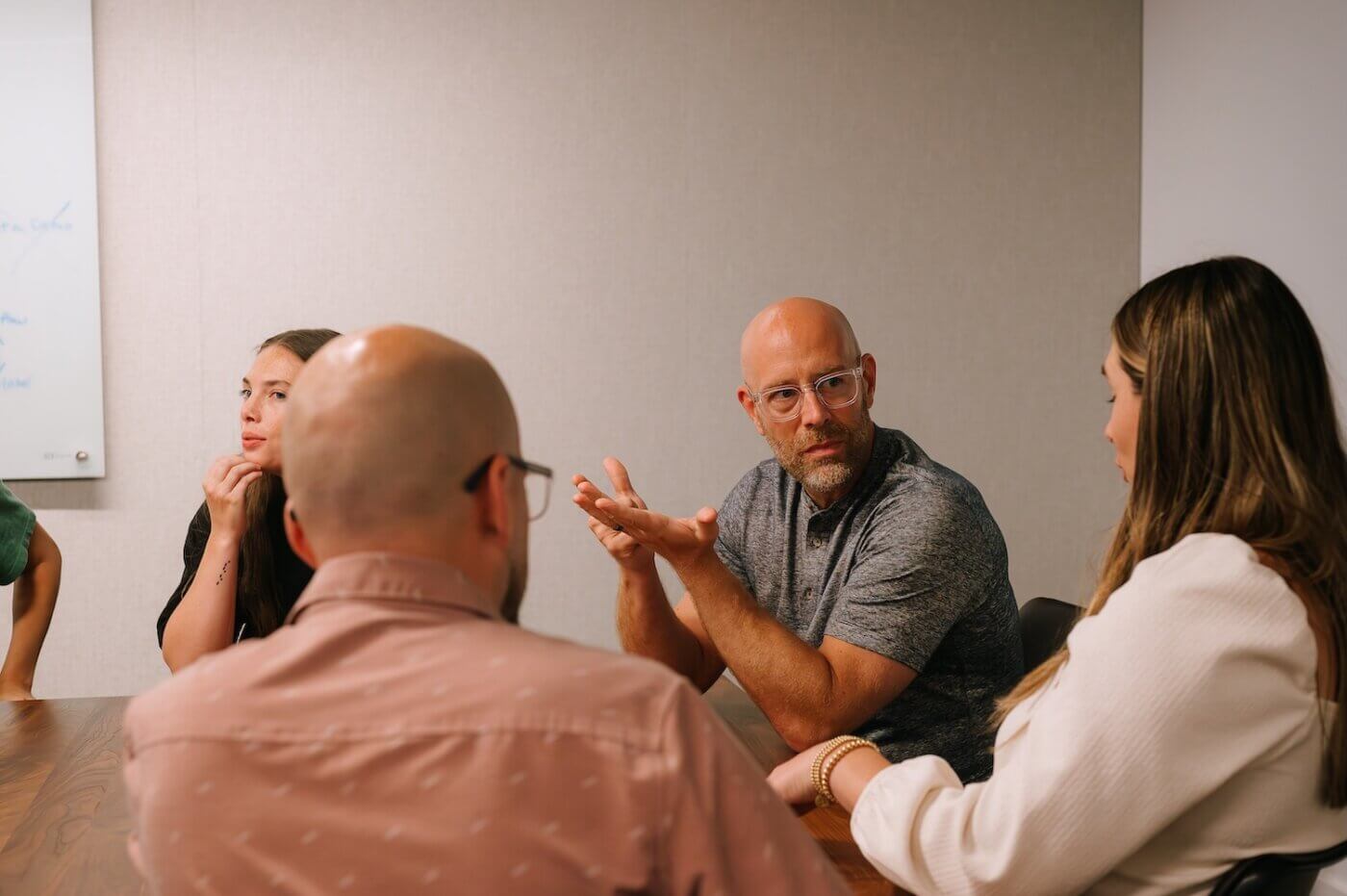 Jason sitting at a table explaining revops to the team
