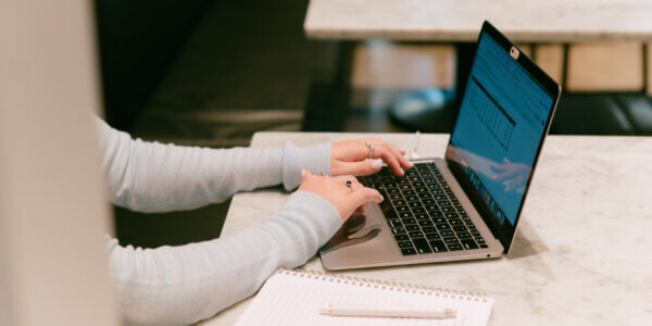 Hands typing on a laptop with GA4