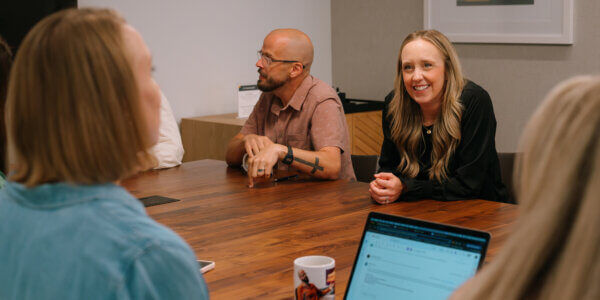 Marketing team sitting around a table discussing the marketing strategy