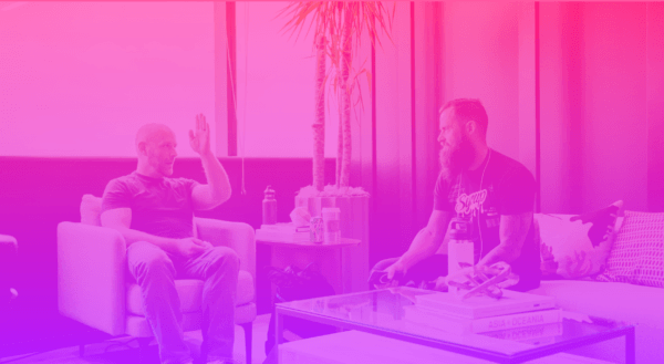 Two men sitting in chairs talking about managing marketing investments