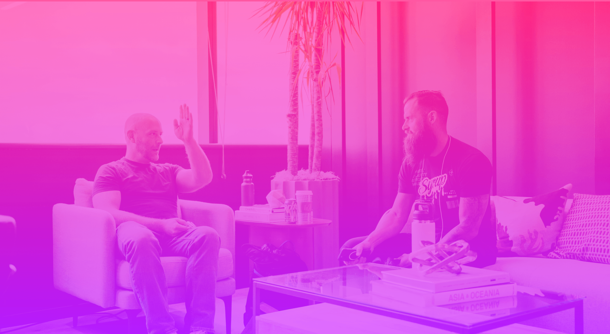 Two men sitting in chairs talking about managing marketing investments