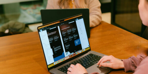 Designer creating brand guide on laptop computer