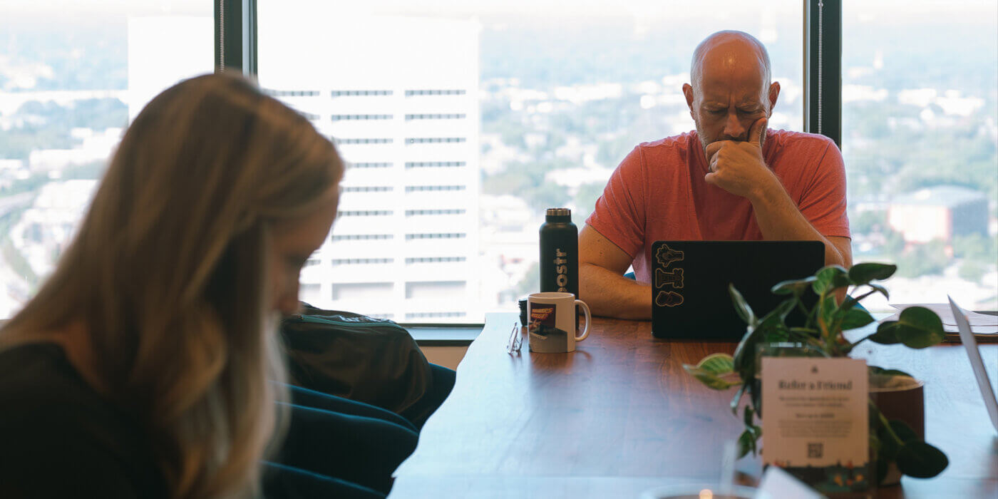 Jason looking at laptop with b2b performance marketing