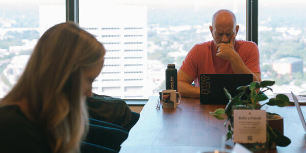 Jason looking at laptop with b2b performance marketing