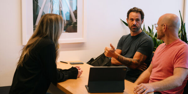 Benj, Jason and Kate sitting around a table discussing B2B marketing experimentation