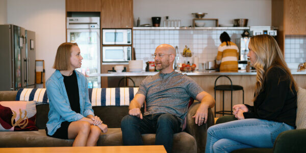 3 people sitting on couches discussing marketing budget allocation